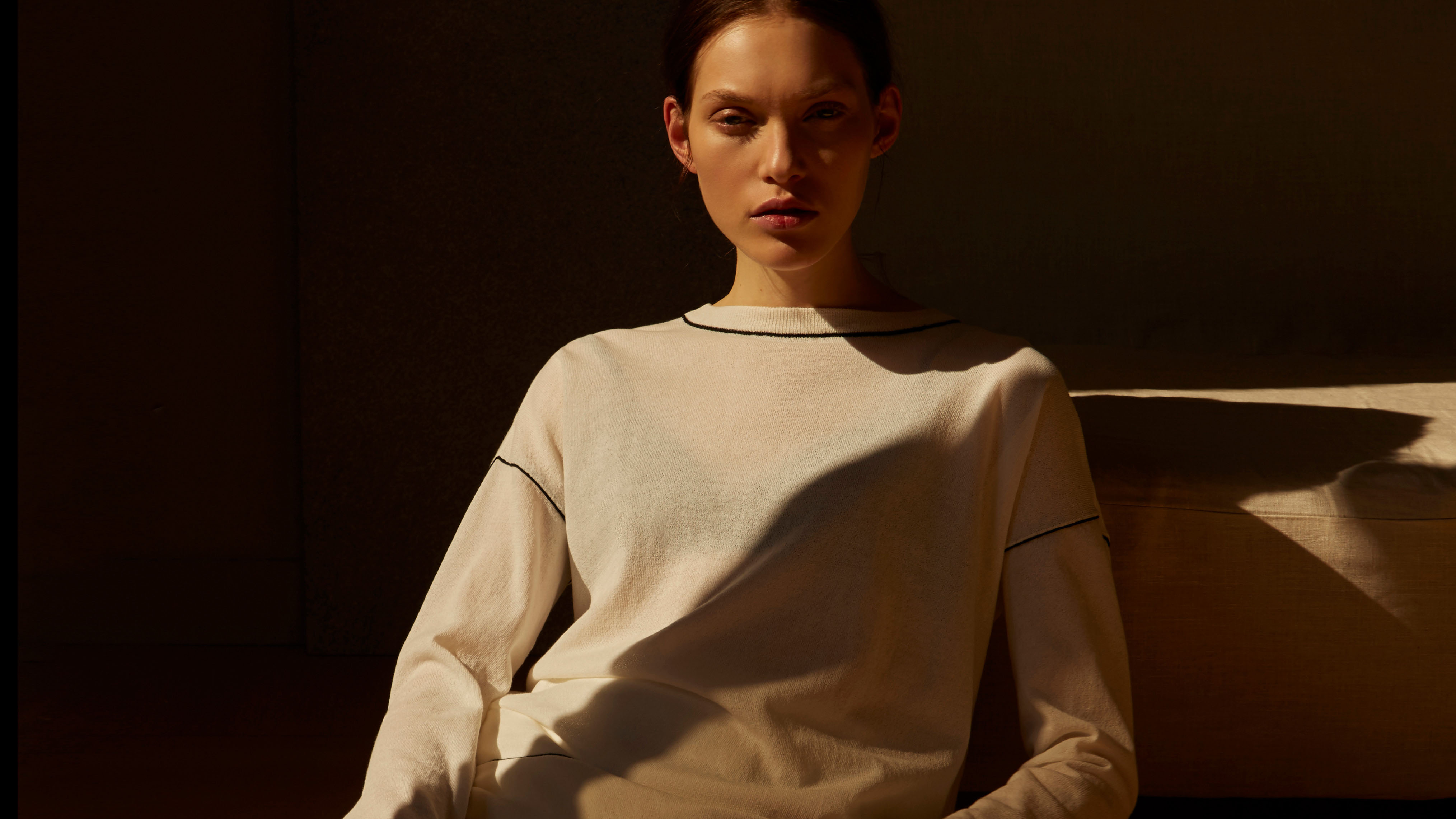 The Shelter Creative image of woman seated on a chair, with natural light illuminating the room. For Adolfo Domínguez by Dario Vazquez